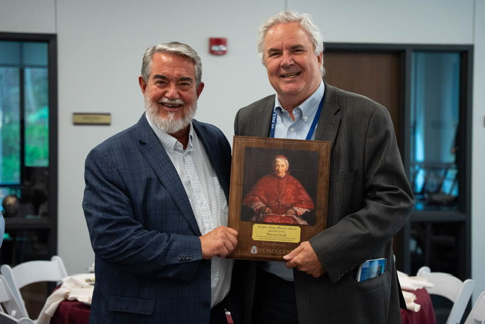 Dr. Scott Hahn of the St. Paul Center presents his former classmate Marcus Grodi with the Cardinal Newman Award at the 2025 Clergy Convert Conference.